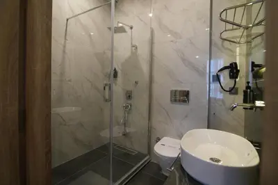 a bathroom with a shower and a toilet and a sink at Kent Room Hotel in Kapaklı
