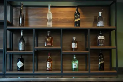 a shelf filled with lots of bottles of alcohol at Kent Room Hotel in Kapaklı