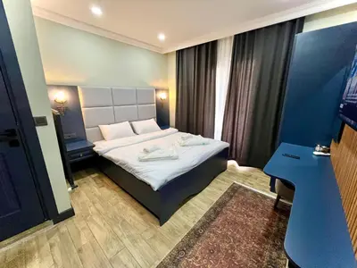 a small room with a bed and a desk at Miller Home's in Istanbul