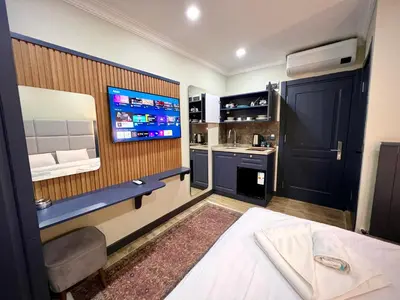 a bedroom with a bed and a tv on a wall at Miller Home's in Istanbul