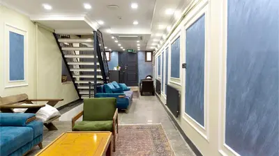 a living room with blue couches and a staircase at Miller Home's in Istanbul