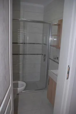 a bathroom with a shower with a toilet and a sink at Ozcans Pera Flats 2 in Istanbul