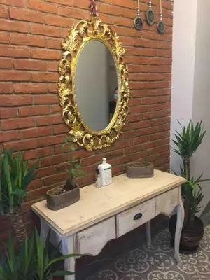 a mirror on a brick wall next to a sink at Ozcans Pera Flats 2 in Istanbul