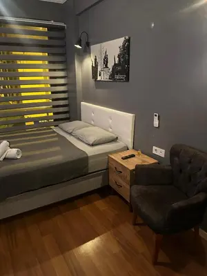 a small bedroom with a bed and a chair at Besiktas Guest House in Istanbul