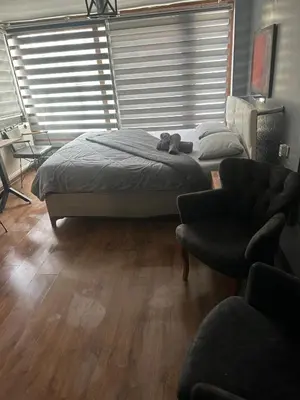a bedroom with a bed and a couch and a chair at Besiktas Guest House in Istanbul