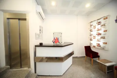 a bathroom with a sink and a red chair at Beyaz Köşk Hotel in Istanbul
