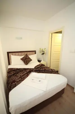 a bedroom with a large bed with a white bedspread at Beyaz Köşk Hotel in Istanbul