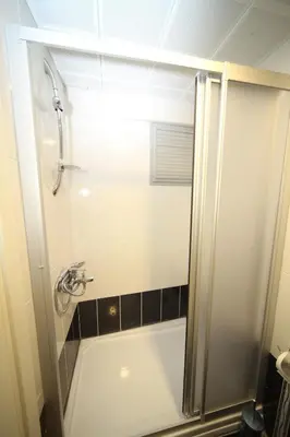 a small bathroom with a shower and a bath tub at Beyaz Köşk Hotel in Istanbul