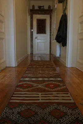 a hallway with a door and a rug on the floor at Stunning 5 Bedroom Sunlit Apartment Galata in Istanbul
