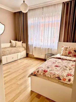 a bedroom with two beds and a window at sultans corner in Istanbul