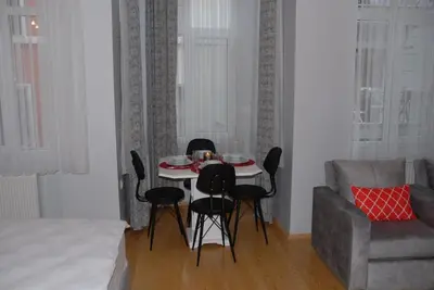 a living room with a table and chairs and a couch at Ozcans Pera Flats 3 in Istanbul
