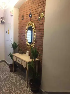 a room with a table and a mirror on a brick wall at Ozcans Pera Flats 3 in Istanbul