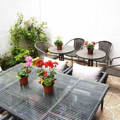 a patio with tables and chairs with flowers on it at Modern apartment in the center of Kadıköy in Istanbul