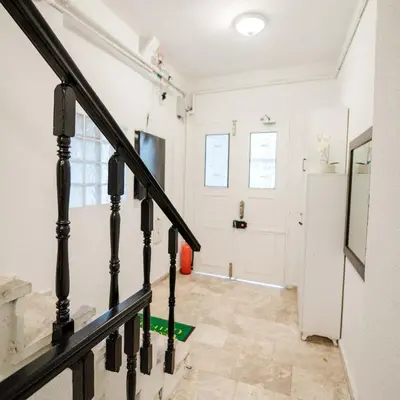 a staircase in a room with white walls and a door at Modern apartment in the center of Kadıköy in Istanbul