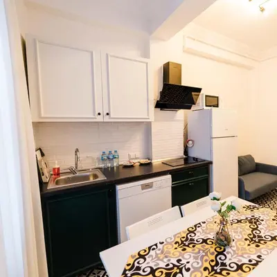 a small kitchen with a sink and a refrigerator at Modern apartment in the center of Kadıköy in Istanbul