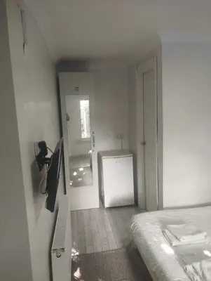 a bedroom with a bed and a door to a bathroom at Şişli Suites - Room 14 in Istanbul