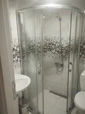 a bathroom with a shower and a toilet and a sink at Şişli Suites - Room 14 in Istanbul