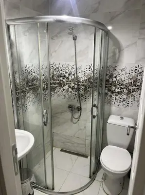 a bathroom with a shower with a toilet and a sink at Şişli Suites - Room 14 in Istanbul