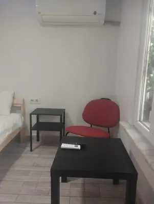 a living room with a red chair and a table at Şişli Suites - Room 14 in Istanbul