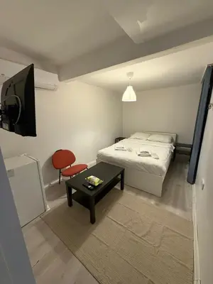 a small bedroom with a bed and a table at Şişli Suites - Room42 in Istanbul