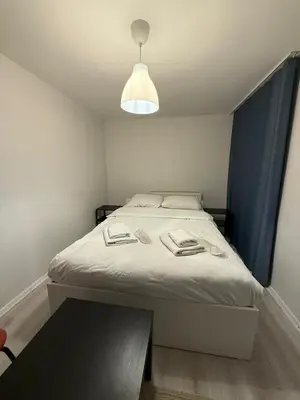a small bedroom with a bed with a table at Şişli Suites - Room42 in Istanbul