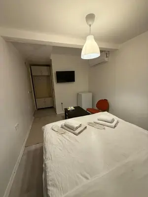 a bedroom with a white bed and a television at Şişli Suites - Room42 in Istanbul