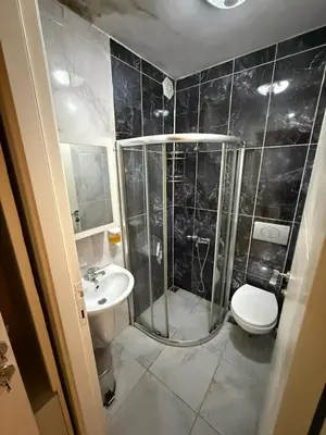 a bathroom with a shower and a toilet and a sink at Şişli Suites - Room42 in Istanbul
