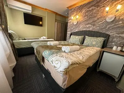 a hotel room with two beds and a tv at Gür Star Hotel in Istanbul