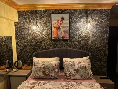 a bedroom with a bed with a painting on the wall at Gür Star Hotel in Istanbul