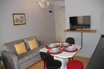 a living room with a couch and a table with chairs at Ozcans Pera Flats 8 in Istanbul