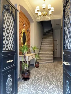 a hallway with blue doors and a staircase with plants at Ozcans Pera Flats 8 in Istanbul