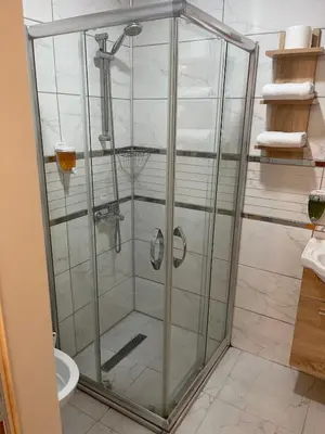 a shower with a glass enclosure in a bathroom at Ozcans Pera Flats 9 in Istanbul