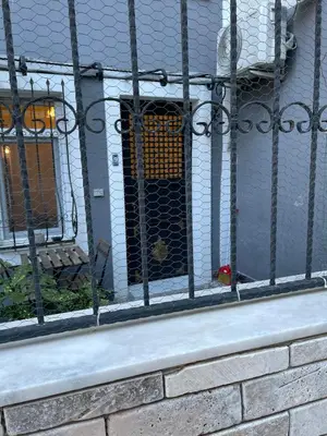 a black fence with a door in a building at Ozcans Pera Flats 9 in Istanbul