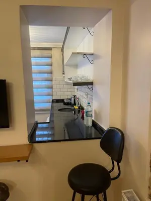 a kitchen with a black counter and a black chair at Ozcans Pera Flats 9 in Istanbul