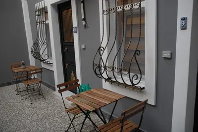 a balcony with two chairs and a table and a door at Ozcans Pera Flats 10 in Istanbul