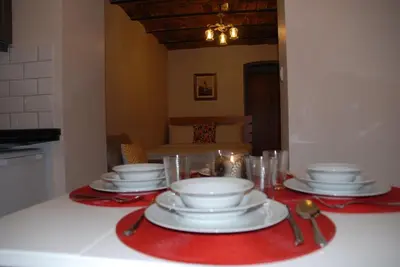 a table with plates and glasses on a red table cloth at Ozcans Pera Flats 10 in Istanbul