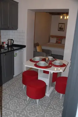 a small kitchen with a table and red chairs at Ozcans Pera Flats 10 in Istanbul