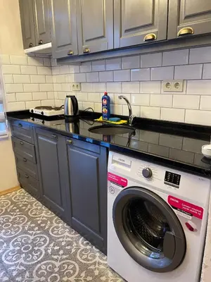 a kitchen with a washing machine in a kitchen at Ozcans Pera Flats 10 in Istanbul