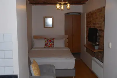 a small bedroom with a bed and a tv at Ozcans Pera Flats 10 in Istanbul
