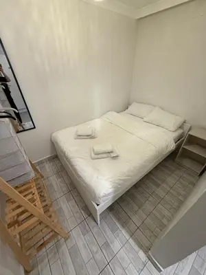 a bedroom with a white bed with two towels on it at Şişli Suites - Room41 in Istanbul