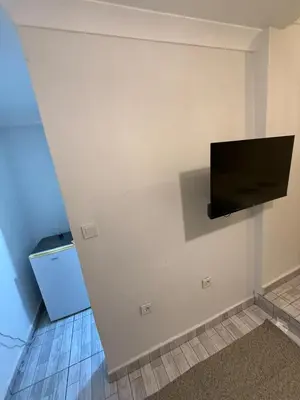 a flat screen tv on a wall in a room at Şişli Suites - Room41 in Istanbul
