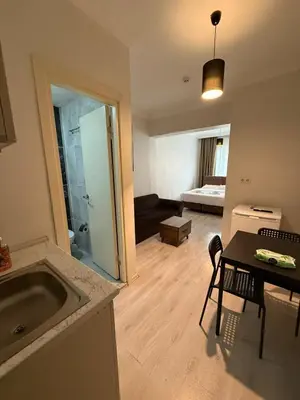 a kitchen and living room with a sink and a table at Şişli Suites - Room26 in Istanbul