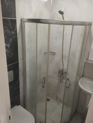 a bathroom with a shower with a toilet and a sink at Şişli Suites - Room46 in Istanbul