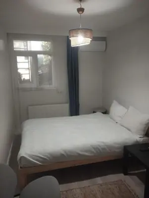 a bedroom with a white bed with a window at Şişli Suites - Room47 in Istanbul