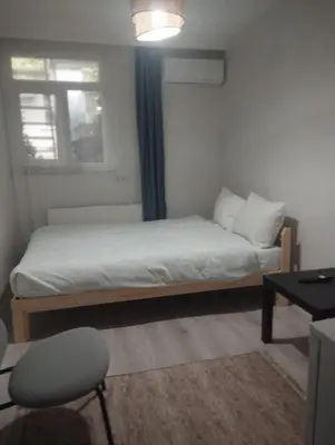 a small bedroom with a bed and a chair at Şişli Suites - Room47 in Istanbul