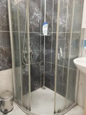 a shower with a glass door in a bathroom at Şişli Suites - Room47 in Istanbul