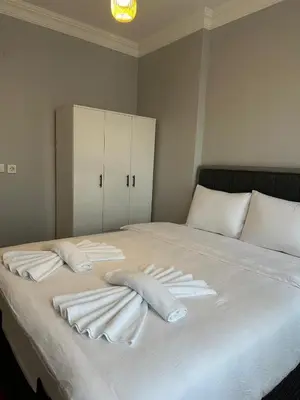 a white bed with two pillows on top of it at Ozcans Sururi Pera Flats 2 in Istanbul