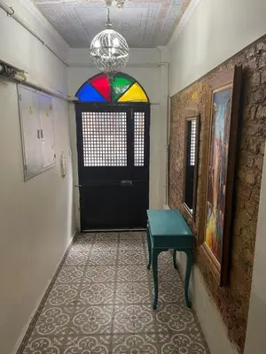 a hallway with a black door and a colorful window at Ozcans Sururi Pera Flats 8 in Istanbul