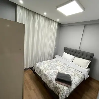 a bedroom with a bed with a large window at Modern Comfort Steps from Taksim in Istanbul