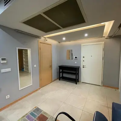 a room with a ceiling with a table and a mirror at Modern Comfort Steps from Taksim in Istanbul
